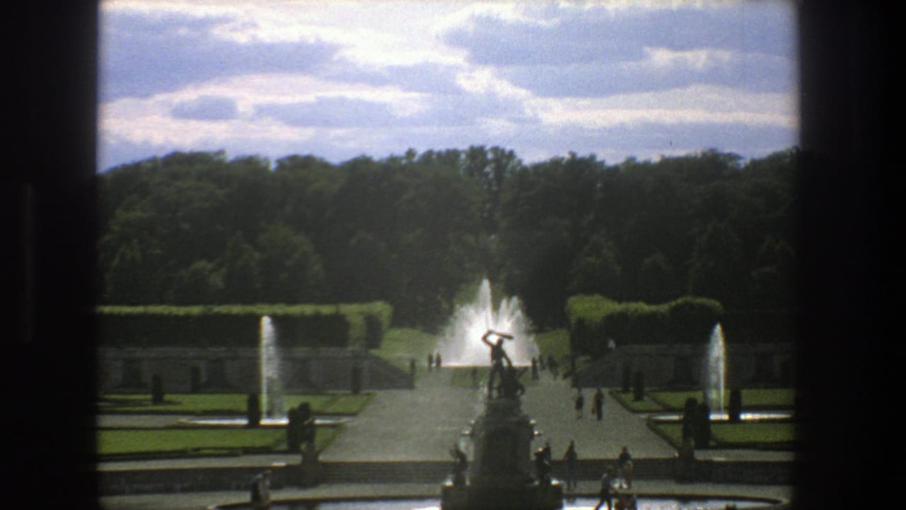 1975 Stockholm travel footage showing a formal garden, central statue, fountains, trees, and small groups of visitors.