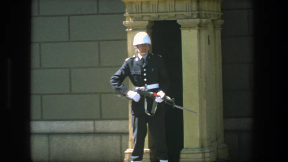 Close Stockholm guard-post frame showing the uniformed soldier, rifle, white helmet and carved sentry box details.