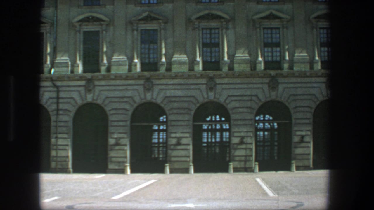 1975 Stockholm exterior frame of a classical stone building, with arched ground-floor openings, upper windows, and a paved open area.