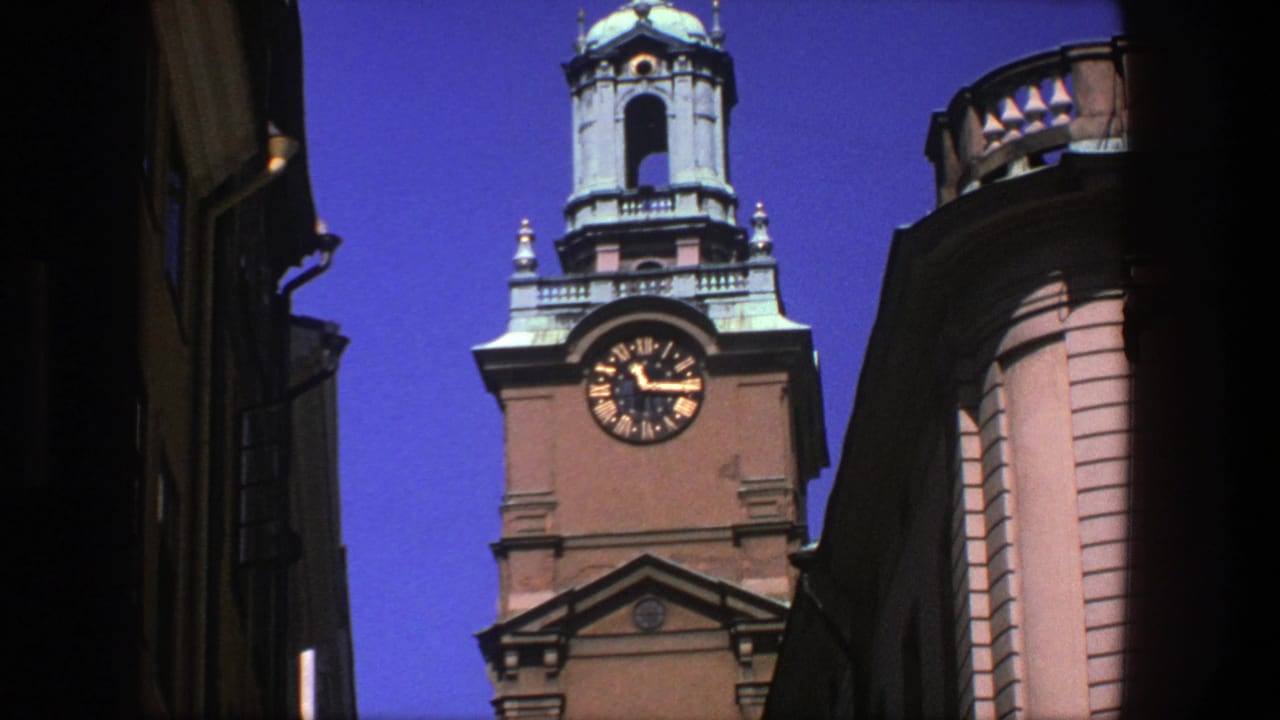 Low-angle Stockholm architectural view with a clocktower, copper-green dome, and neighboring curved facade on 8mm film.