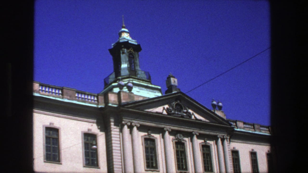 Similar view of the domed building facade with columns and bright blue sky.