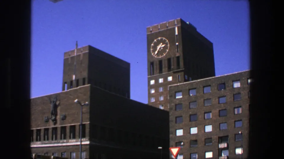 1975 Stockholm 8mm still showing the clock tower and adjacent brick architecture from a low visitor-shot viewpoint.