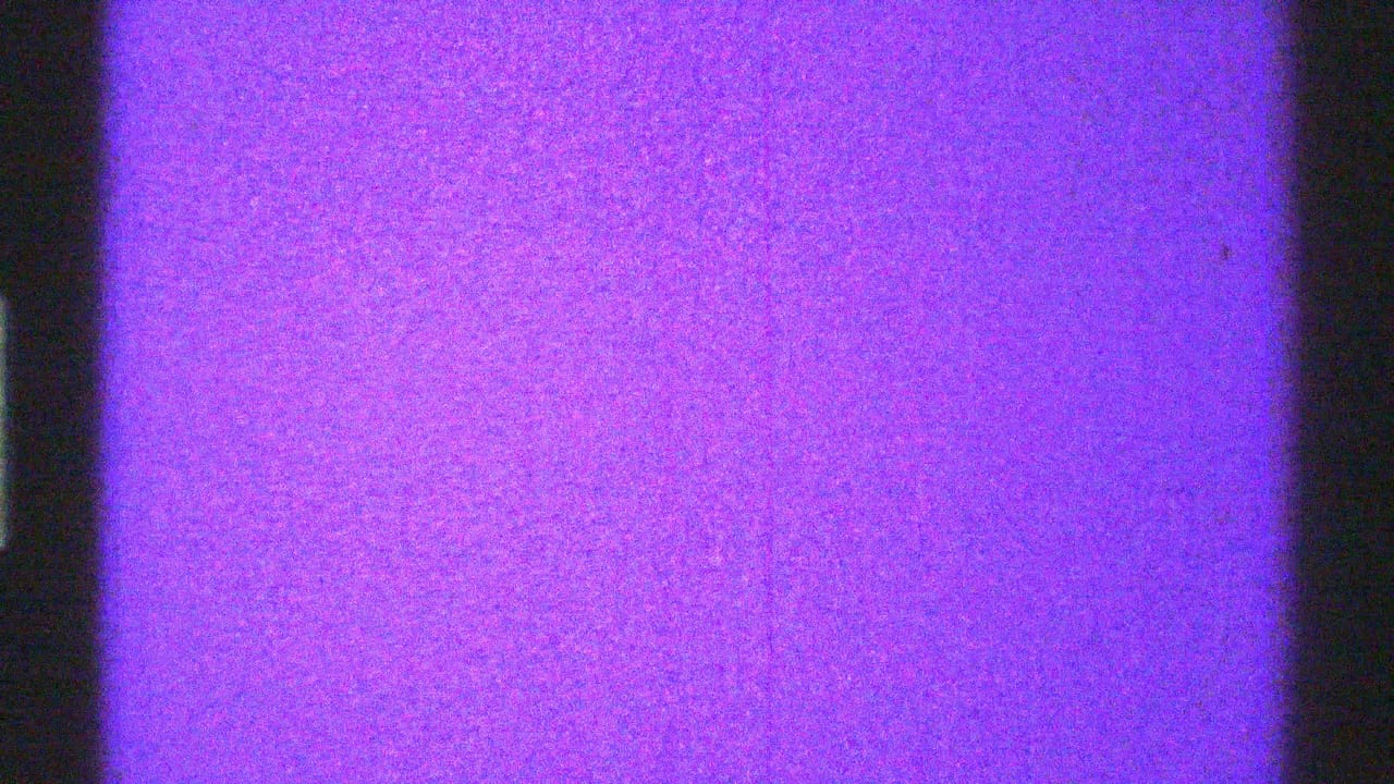 Purple static field with dark vertical bands and visible film grain.