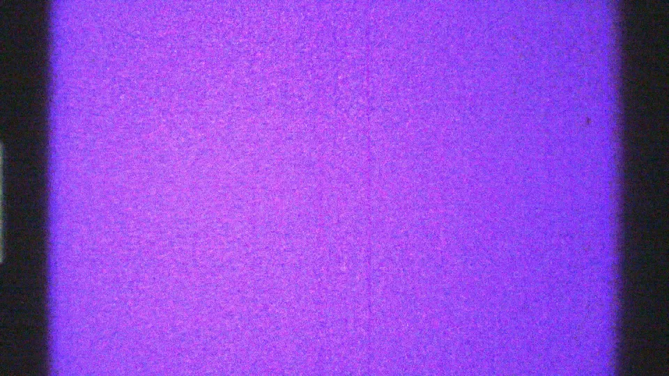 Arizona 1969 8mm frame showing a purple static-like screen surface with dark vertical bands and grain.
