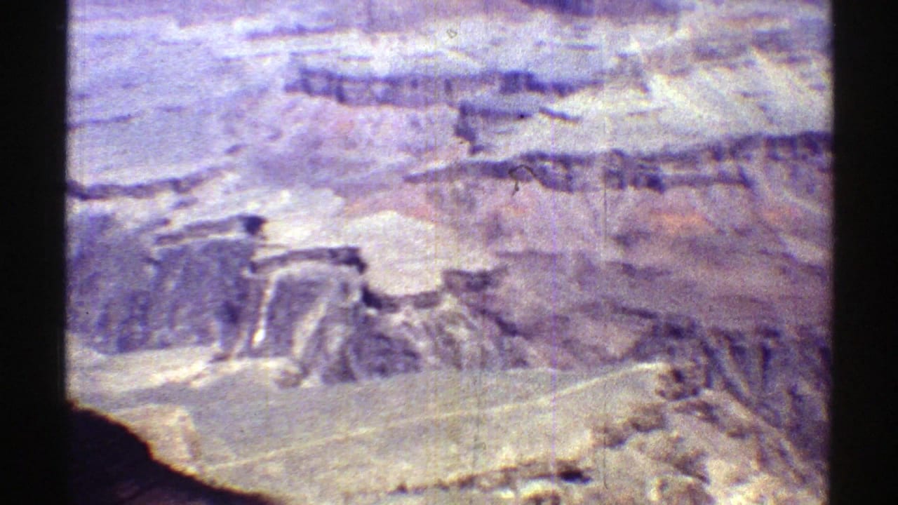 Layered canyon landscape seen through a dark film-frame border.