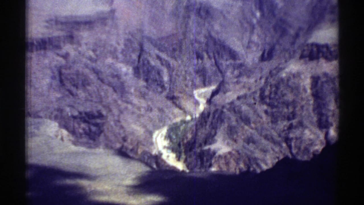 Canyon shoreline and steep rock formations seen from above.