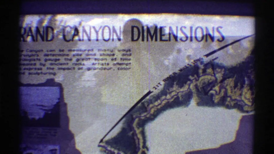Final 1969 Arizona frame showing the Grand Canyon Dimensions sign with a drawn canyon profile, printed explanation, and aged 8mm color shift.