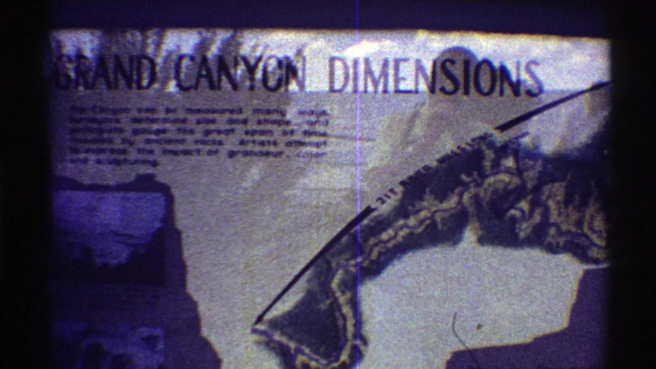 1969 Arizona 8mm frame showing a Grand Canyon Dimensions informational sign with text and a partial canyon map.