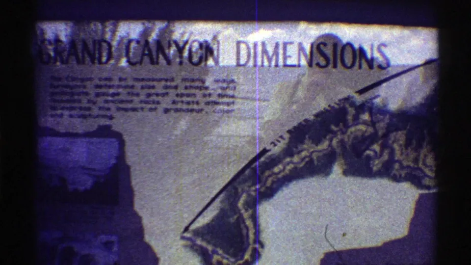 1969 Arizona 8mm frame showing a Grand Canyon Dimensions informational sign with text and a partial canyon map.