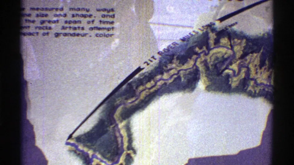1969 Arizona 8mm frame showing a closer view of the Grand Canyon sign map and partially cropped explanatory text.