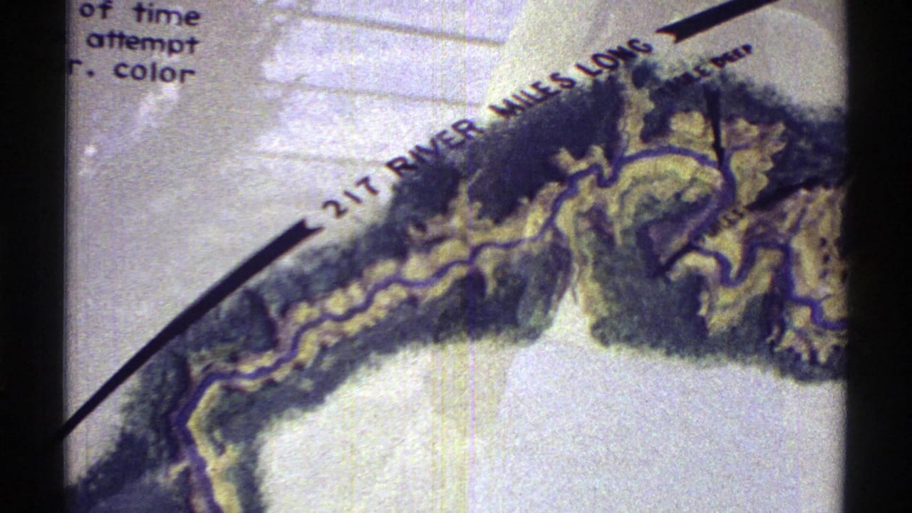 1969 Arizona 8mm frame showing a tilted hand-drawn river map with topographical shading and a “217 RIVER MILES LONG” label.