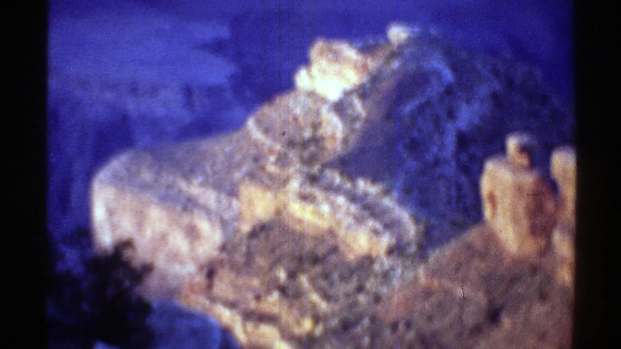 1969 Arizona 8mm frame showing a soft, color-shifted close view of Grand Canyon rock forms and shadowed foreground edges.