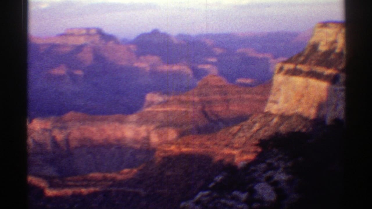 Arizona canyon view from 1969 home-movie footage, with layered rock formations and warm fading light.