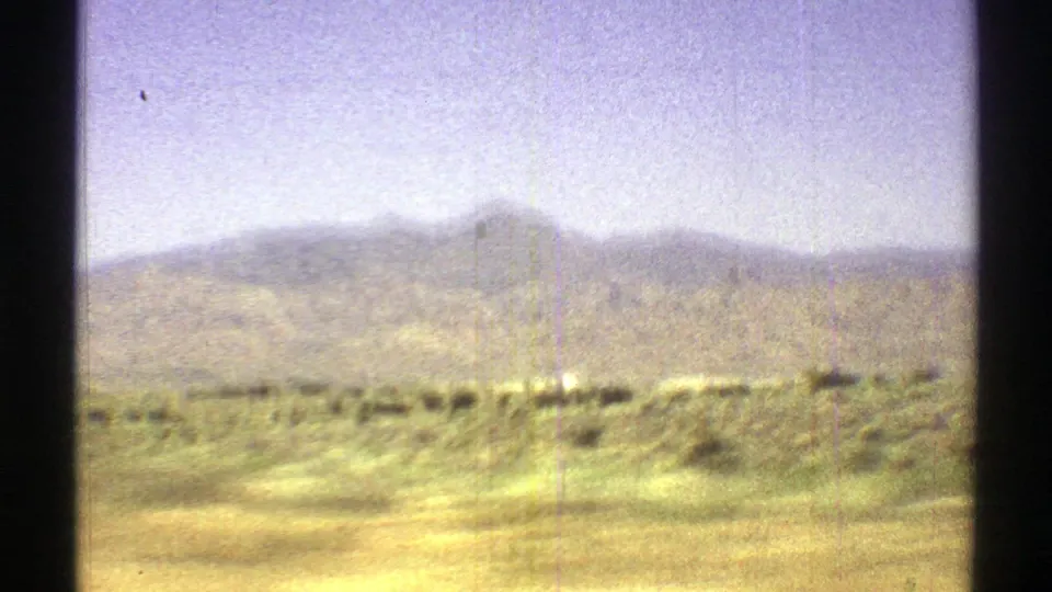 1969 Arizona landscape view showing open scrubland and soft distant mountains under a bright hazy sky.