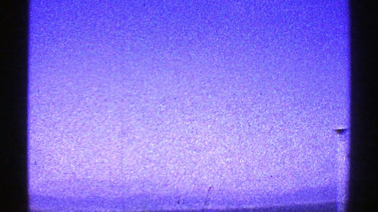 Mostly blue-purple sky with a dark vertical edge at left and a faint lower band.