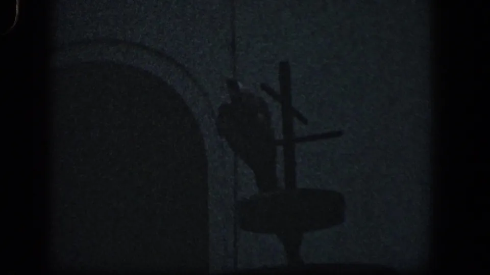 1961 Baltimore 8mm frame showing dark outdoor storm debris, an arched form, and a cross-shaped silhouette against a dim sky.