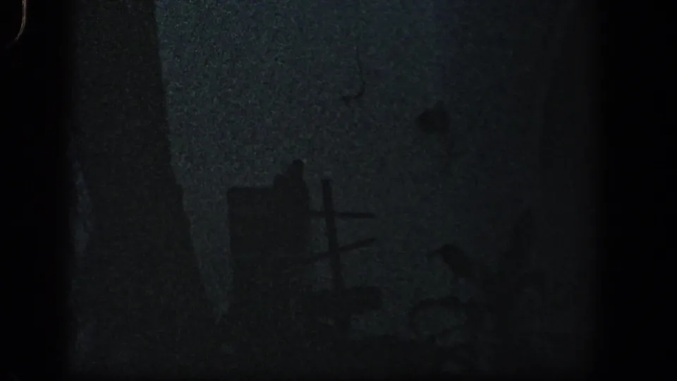 Low-light 1961 Baltimore frame with a cross-shaped object, scattered damaged pieces, and grainy shadows after a storm.