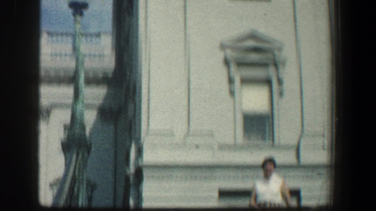 Upper building facade with a woman partly visible at the lower right.