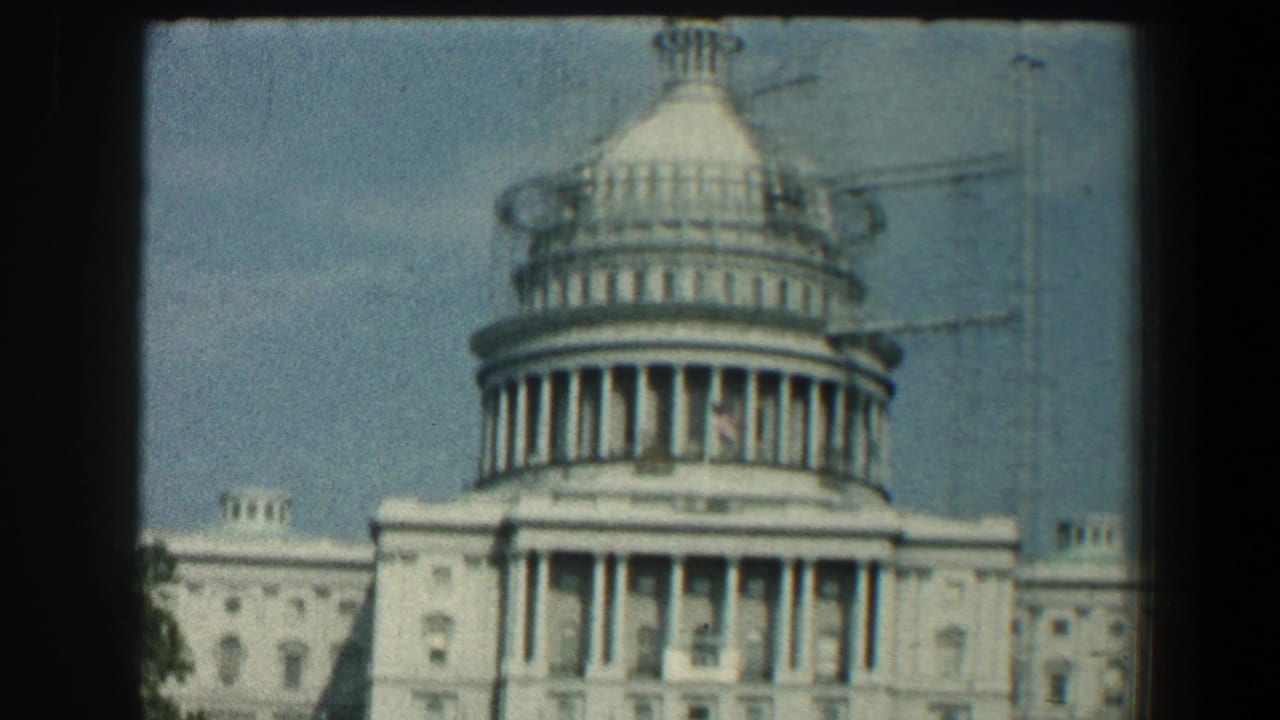 Closer view of the Capitol dome and facade with scaffolding-like lines.