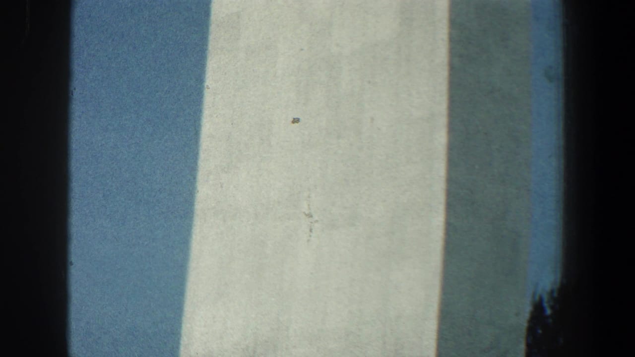 Close view of pale tower surfaces with blue sky and dark shadow between sections.