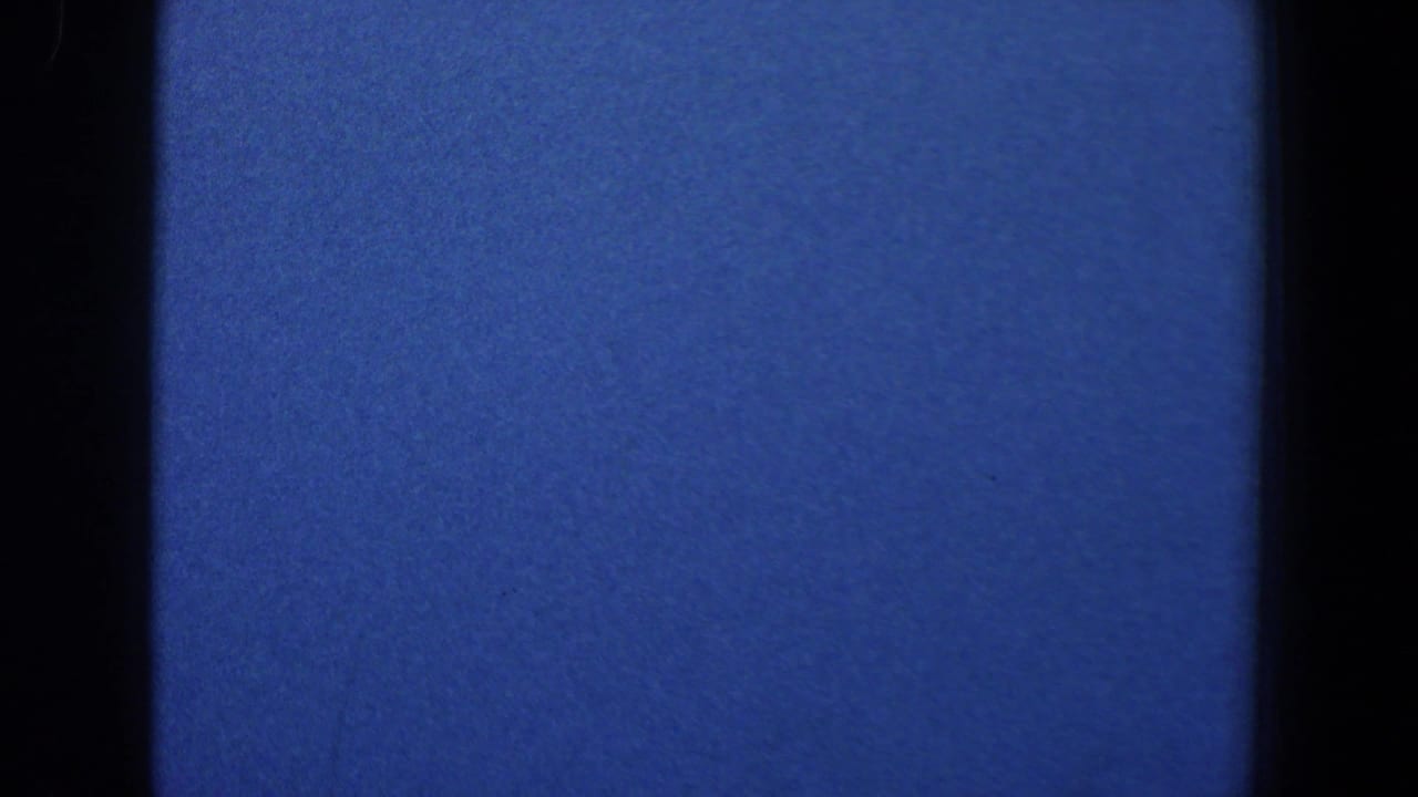 Dark blue frame with vertical film edges and little visible subject detail.