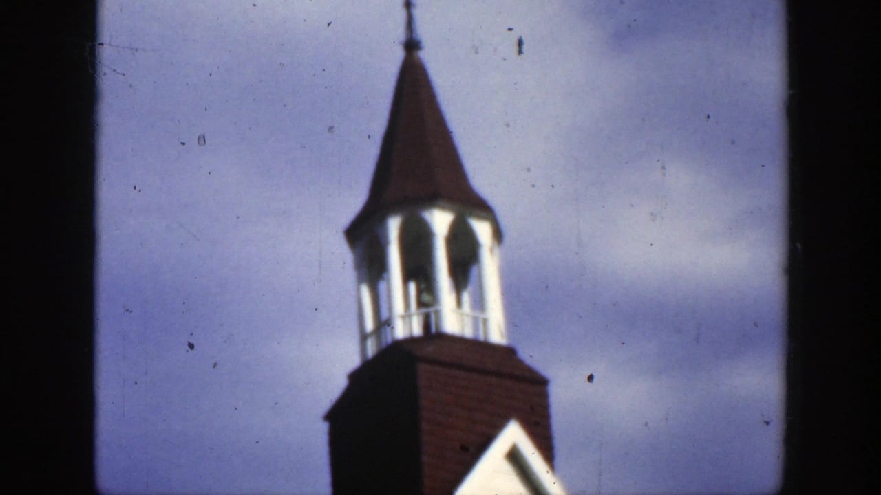 1950 Montreal frame with the church bell tower shifted to the right, showing the cupola, roof, and pale sky.