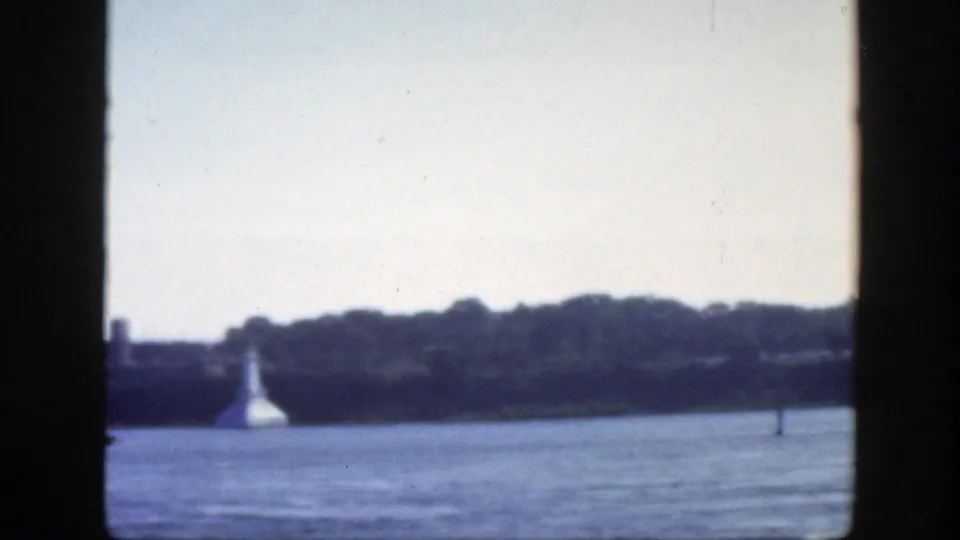 A soft 1950 Montreal riverfront view shows water, a distant wooded bank, a white conical shoreline structure, and a small channel marker.