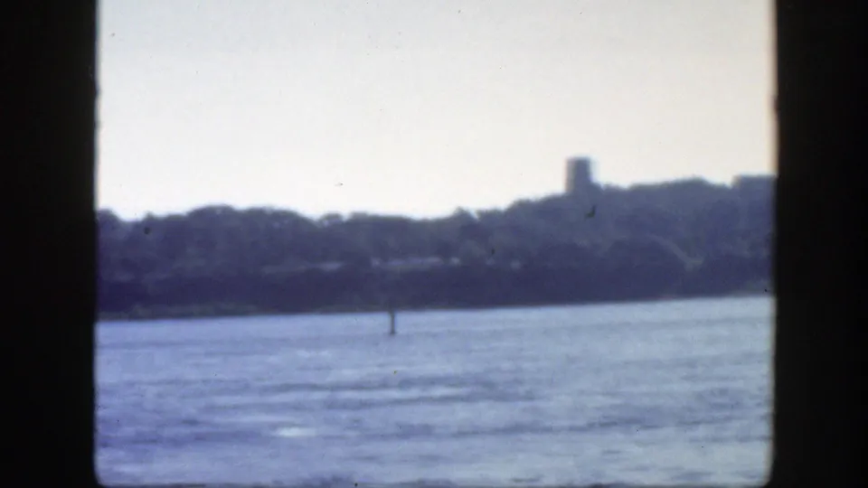 The final 1950 Montreal frame shows the river from a vessel, a tree-lined bank, a distant tower, low shoreline structures, and blue-gray haze.