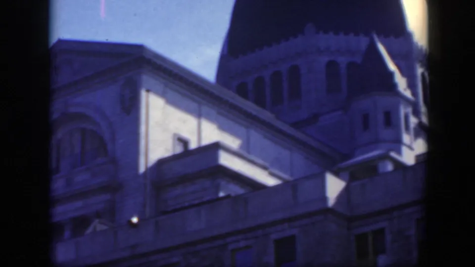 1950 Montreal home-movie close-up of stone architecture and a dark dome-like roof form, seen from a low angle.