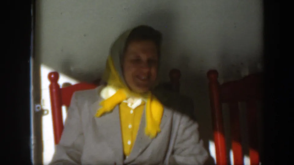 Near the end of the clip, the woman appears without sunglasses, smiling from the red chair in the 1950 Montreal footage.