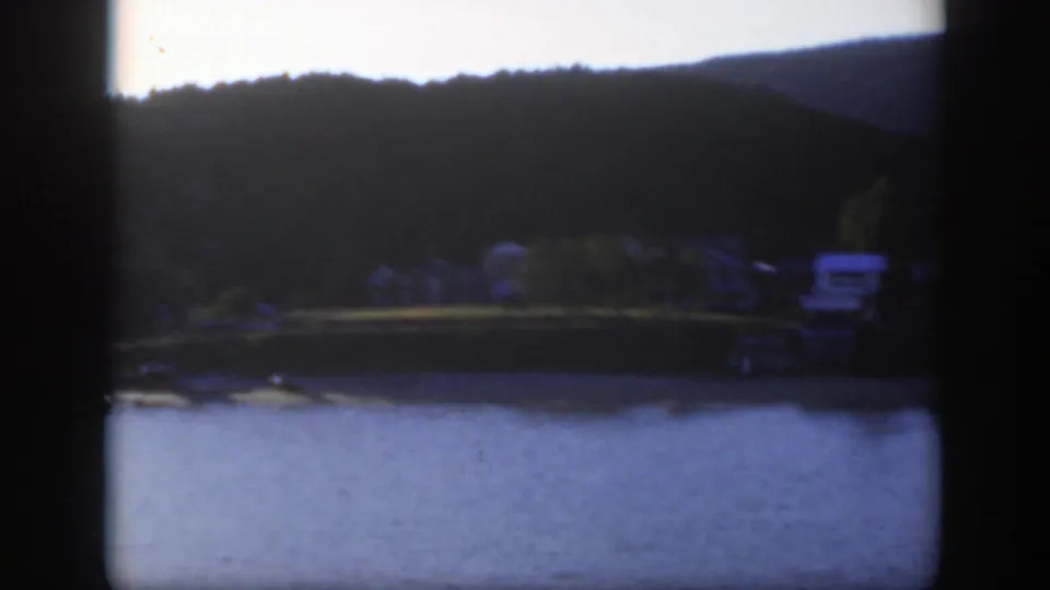A 1950 Montreal waterfront view shows blue water, trees, and small houses along the far shore.