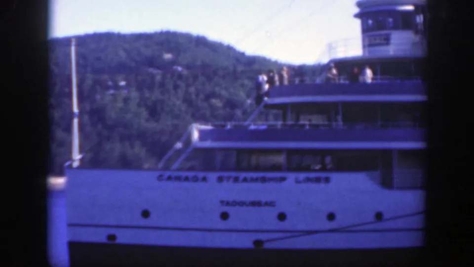 Closer 1950 Montreal view of the Tadoussac passenger vessel, showing Canada Steamship Lines lettering, upper decks, and wooded hillside.