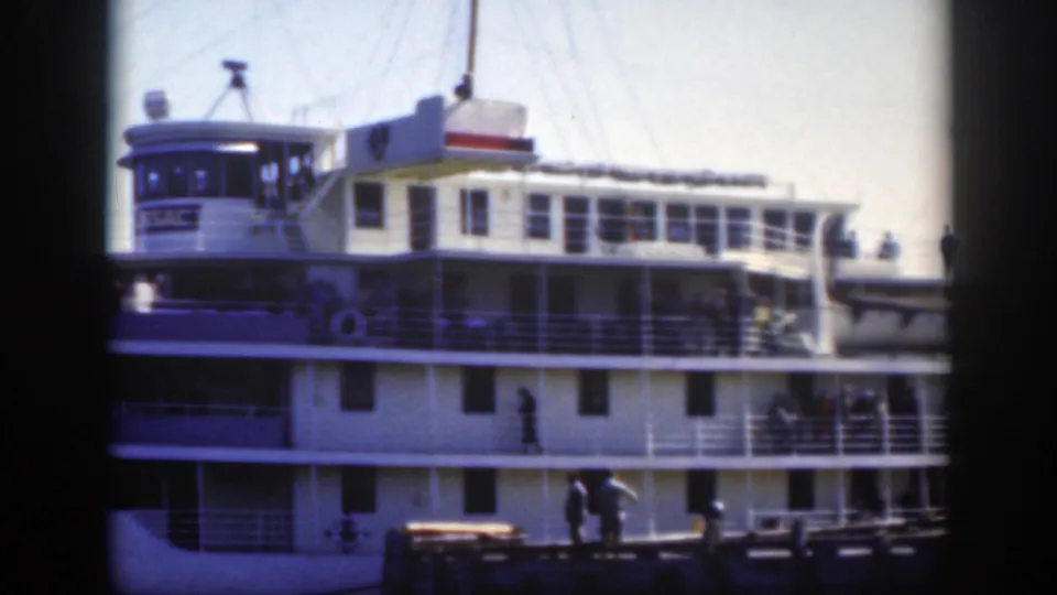 The final frame holds on the docked Tadoussac, with deck railings, upper cabin windows, and people visible aboard and dockside.