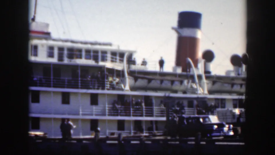 1950 Montreal harbor footage showing the passenger ship's funnel, upper deck, dockside people, and a car in the foreground.
