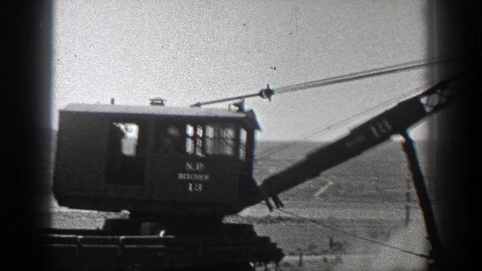 1936 California 8mm frame showing the side of an N.P. Pitcher 13 crane with its boom and cables extended.