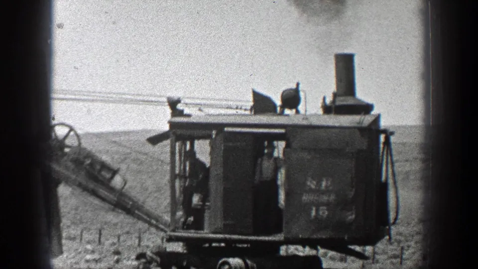 Side view of the marked N.P. DITCHER 15 steam excavator with a worker visible in the cab area.