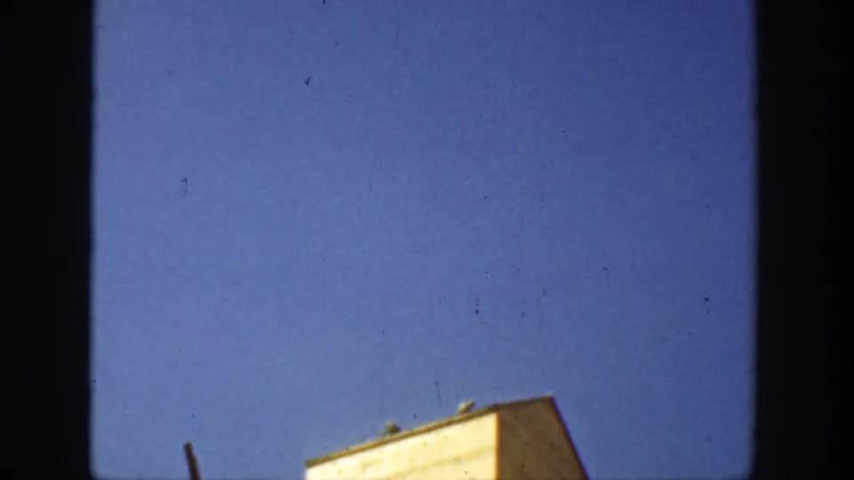 1936 California frame with the grain elevator roofline low in view and a broad blue sky filling most of the image.
