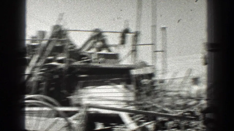 The wagon and mule team pass close to camera, with a person visible beside the rig in the 1936 California footage.