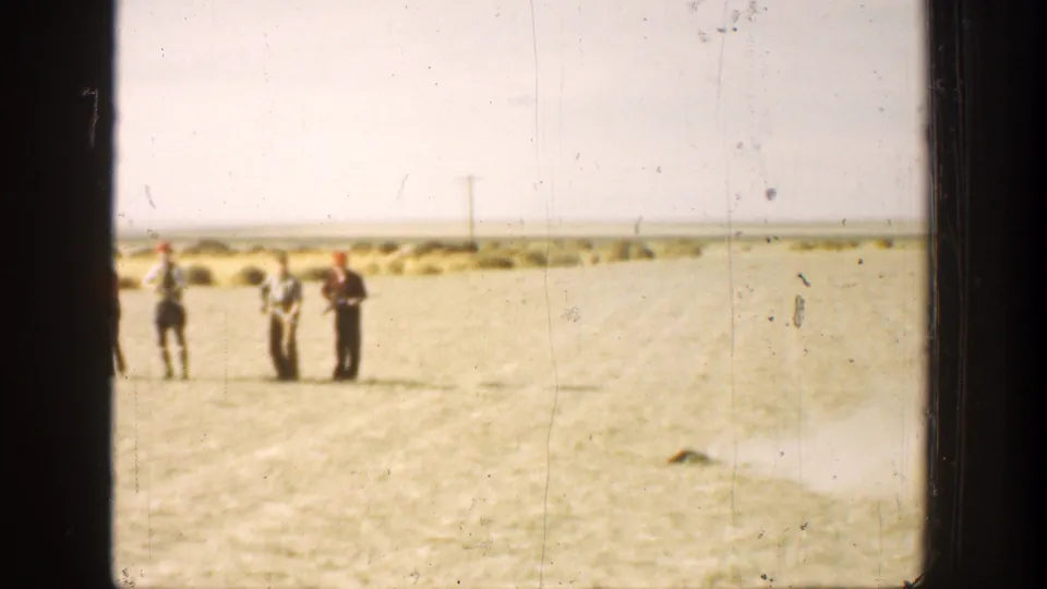 Near the end of the clip, three men are visible in the 1936 California field, with the shooting group partly shifted in frame.
