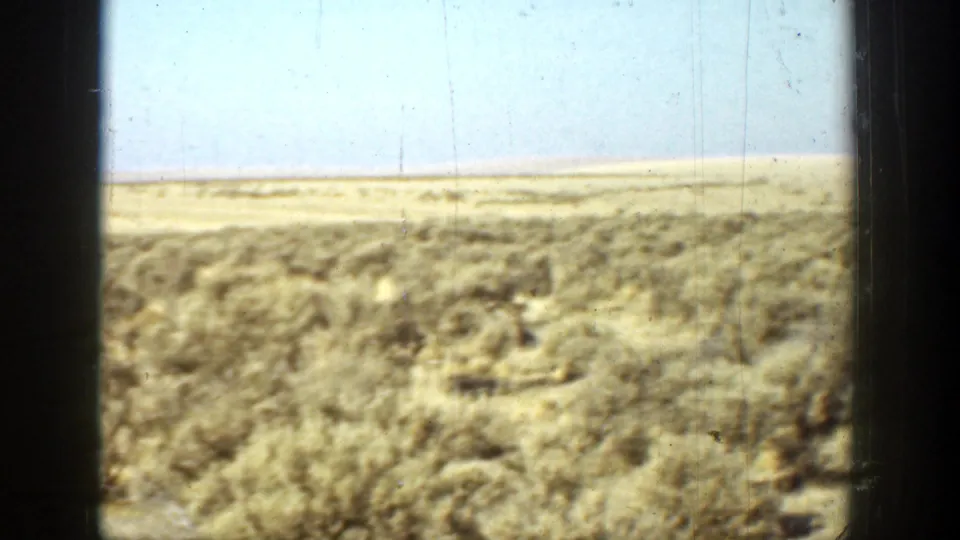 A barren California landscape appears at the end of the clip, with low scrub, flat horizon, and pale blue sky.
