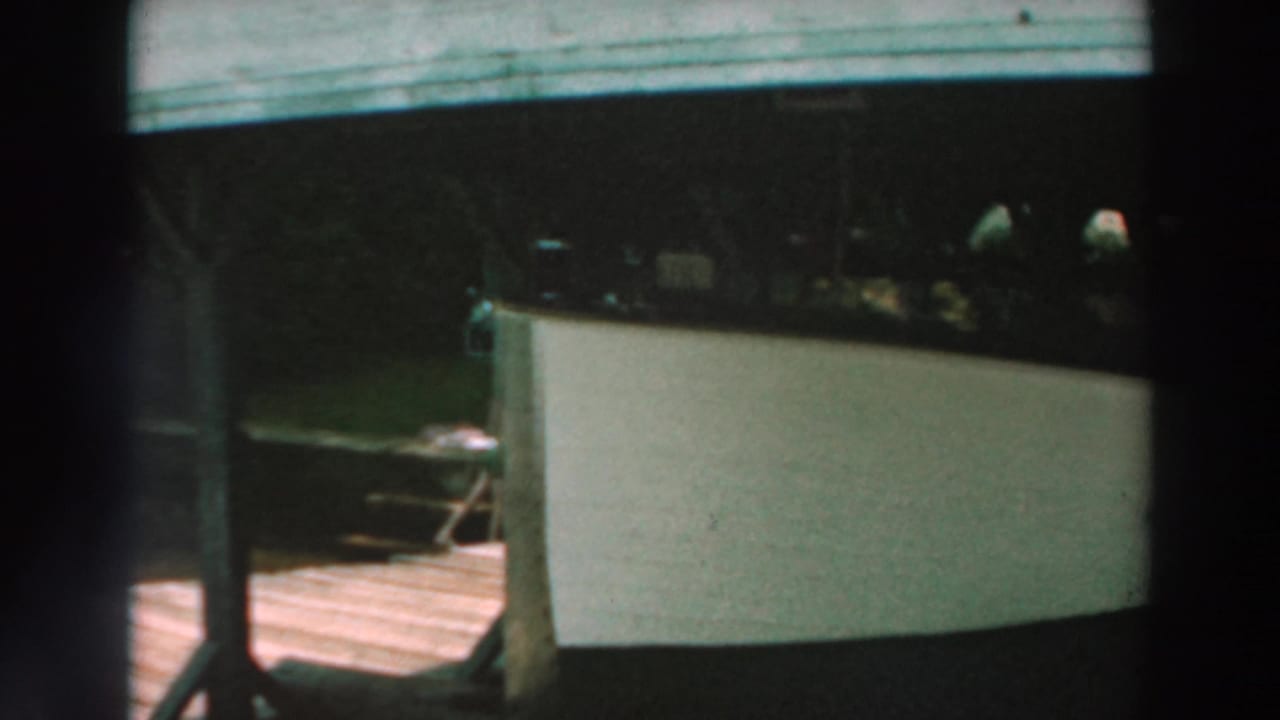 Covered dock and white boat with a small deck area nearby.