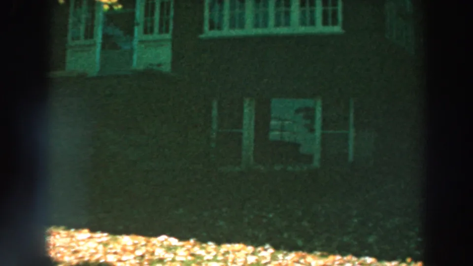Lake Winnebago house exterior with white windows, a doorway area, shaded brickwork, and sunlit leaves near the lawn.
