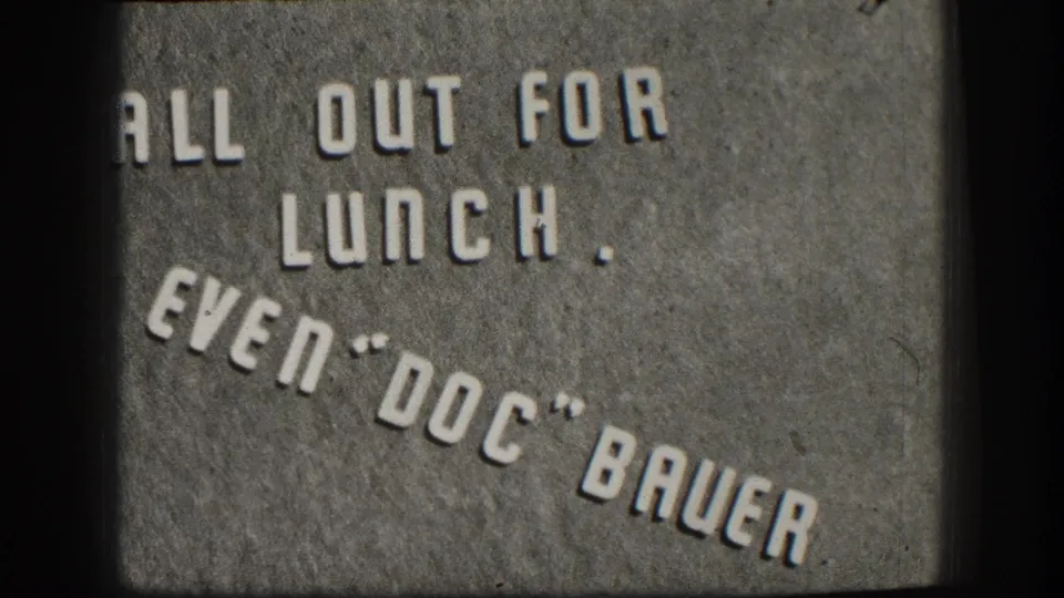 Kansas 1958 home-movie title card with raised letters reading All Out For Lunch, Even Doc Bauer.