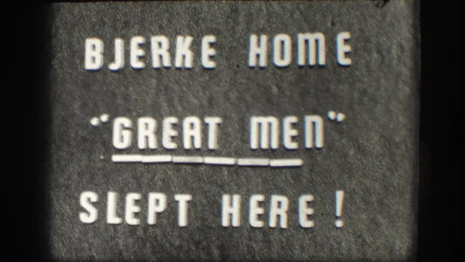 The Bjerke Home plaque fills the 8mm frame, with white raised lettering against a dark stone surface.