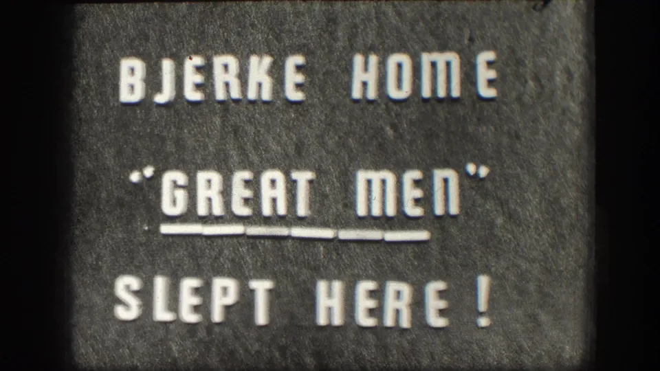 1958 Kansas 8mm title card reading BJERKE HOME "GREAT MEN" SLEPT HERE! with visible film grain and frame edge.