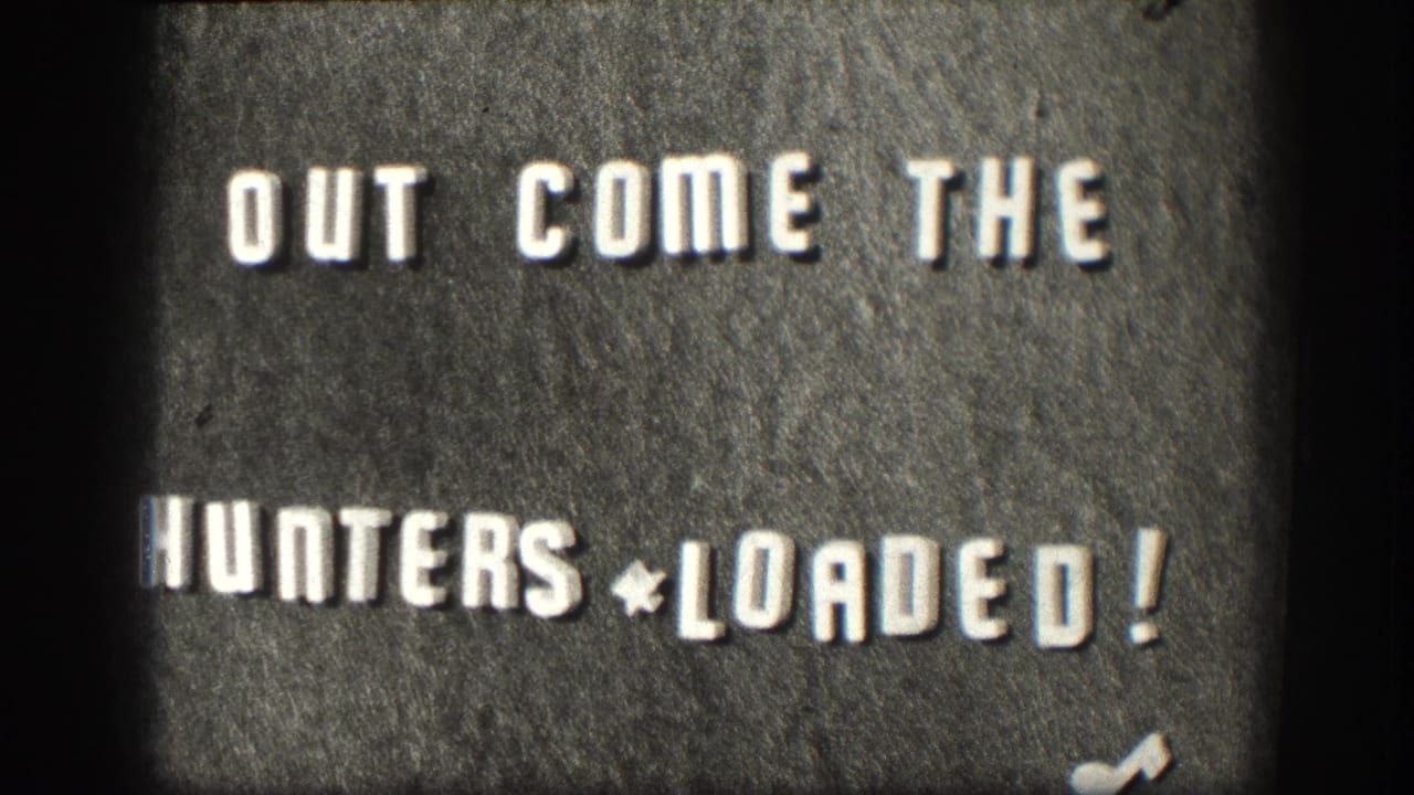 1958 Kansas 8mm title card with bold white text reading OUT COME THE HUNTERS * LOADED! on a dark textured background.