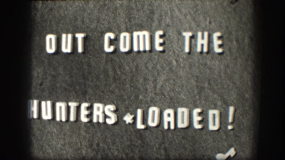 1958 Kansas 8mm title card with bold white text reading OUT COME THE HUNTERS * LOADED! on a dark textured background.