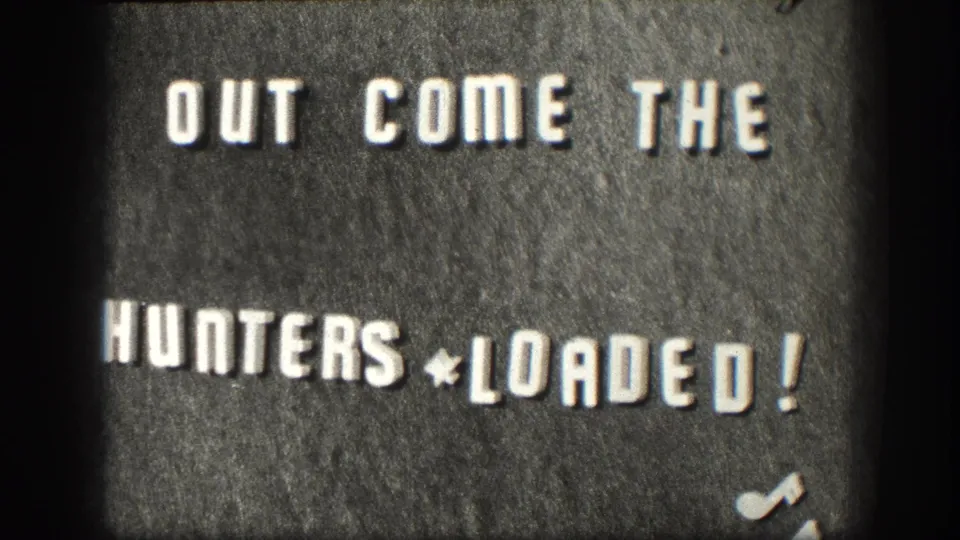 Final sampled frame of the 1958 Kansas 8mm title card, with the white OUT COME THE HUNTERS * LOADED! text still visible.