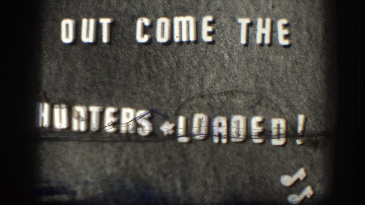 1958 Kansas 8mm title card with the words OUT COME THE HUNTERS LOADED visible on a dark textured surface.