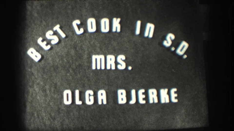 1958 8mm Kansas home-movie title card naming Mrs. Olga Bjerke as Best Cook in S.D.